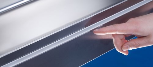 A hand pointing at a seamless metal sheet with heat conduction welding by Laserline diode lasers