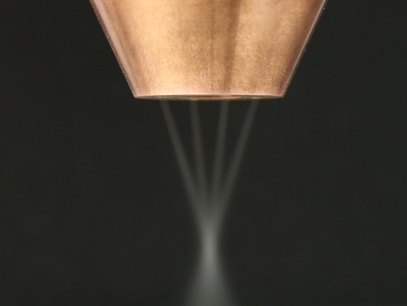 Closeup of the laser stream of an optic with a multi stream nozzle by Laserline diode lasers