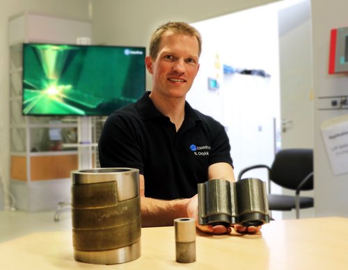 Laserline employee presenting three laser cladding samples by Laserline diode lasers