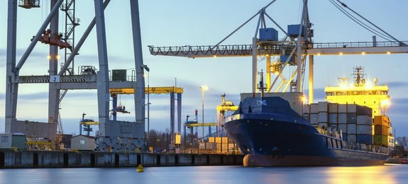 Transportation ship loaded with containers stationed at a port by Laserline diode lasers